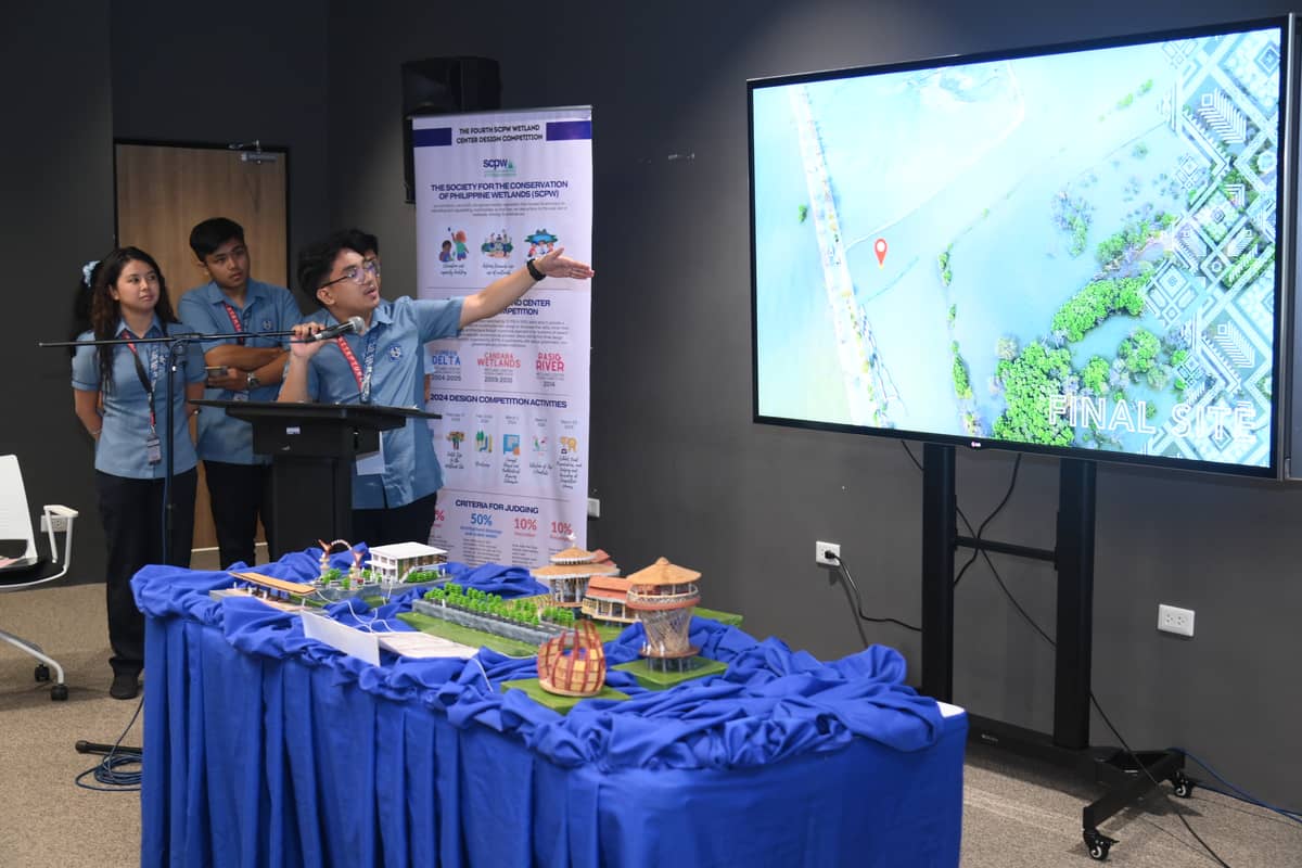 The architecture students of the National University proudly show their wetland design called Talisayan, which bagged the 3rd place in the competition.